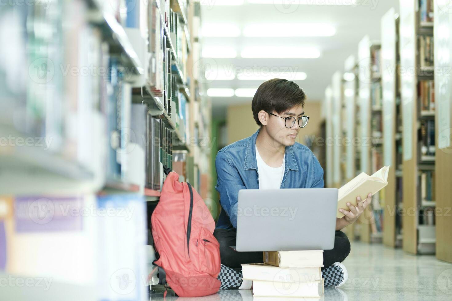 Student sitting and studying at library. photo
