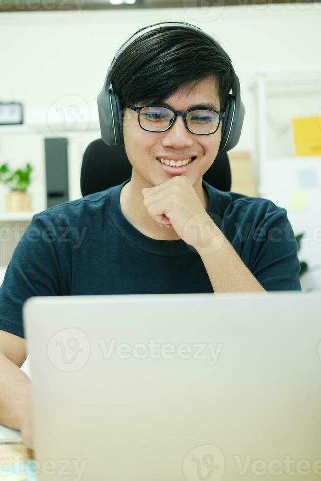Young man study in front of the laptop computer at home photo