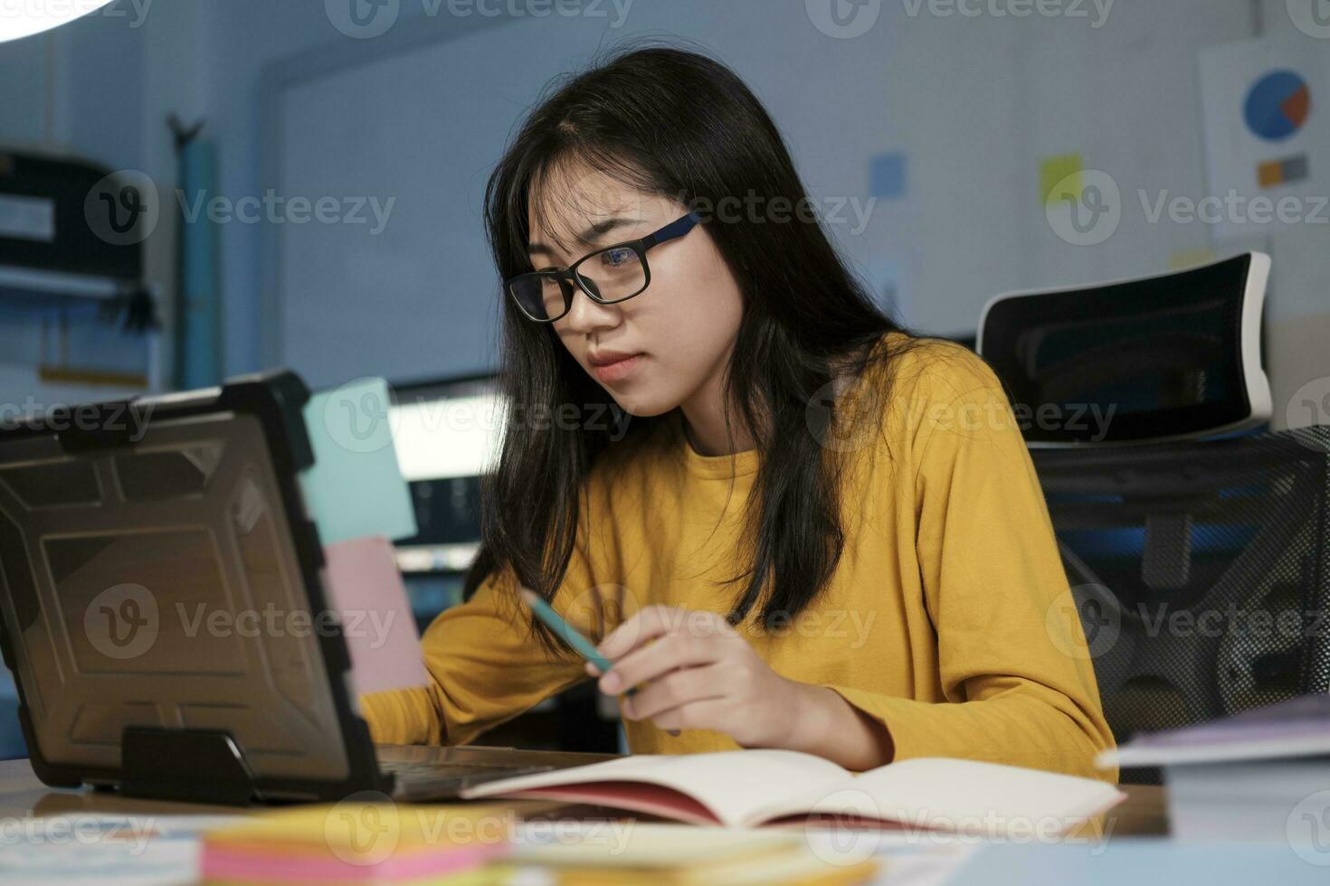 Young woman working on laptop in the office photo