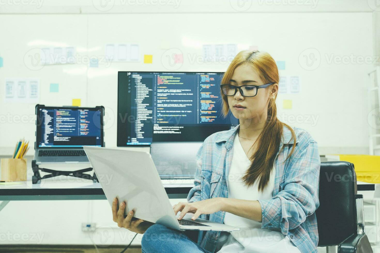 Young programmer or IT specialist satisfied with her work done. photo