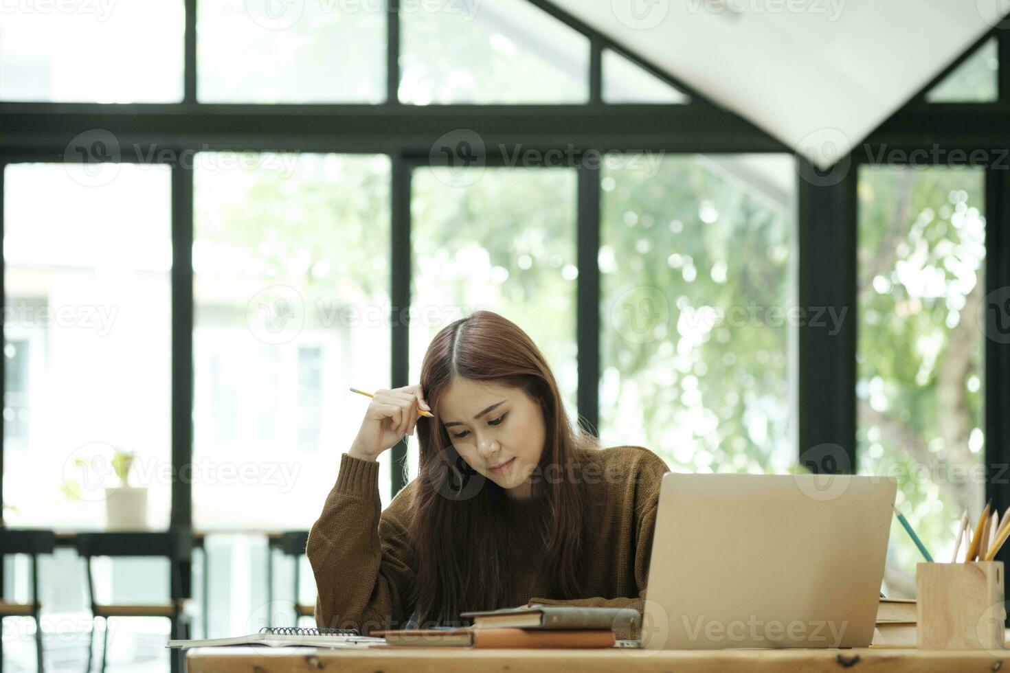 Young collage student using computer and mobile device studying online. photo