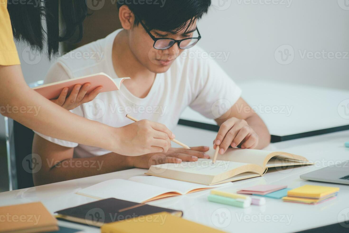 Young students campus helps friend catching up and learning. photo