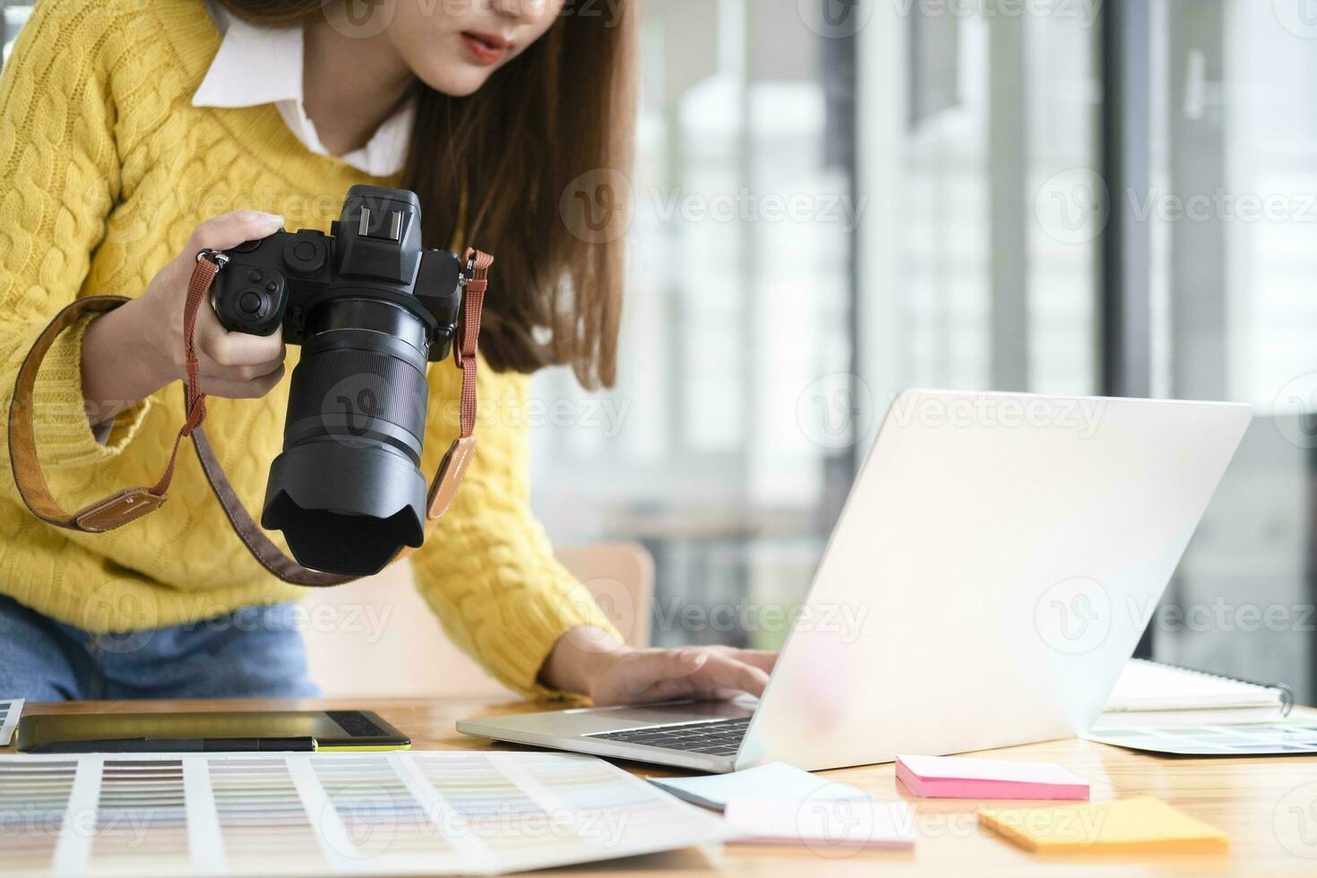 Young photographer checking images from digital camera. photo