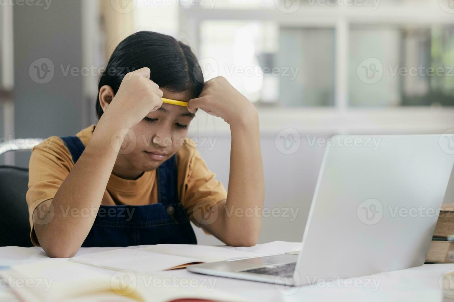 Happy asian girl learning online at home photo