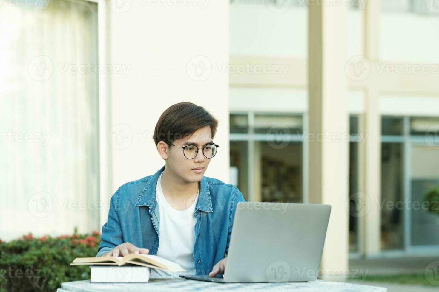 Student studying outdoor using laptop. photo