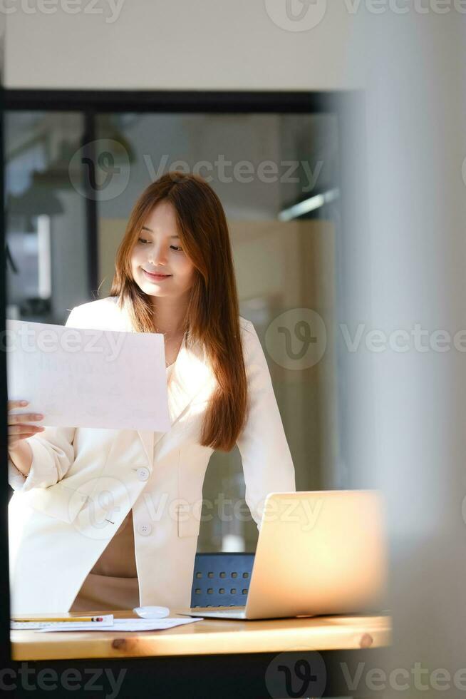 Businesswoman is working at office and using laptop. photo