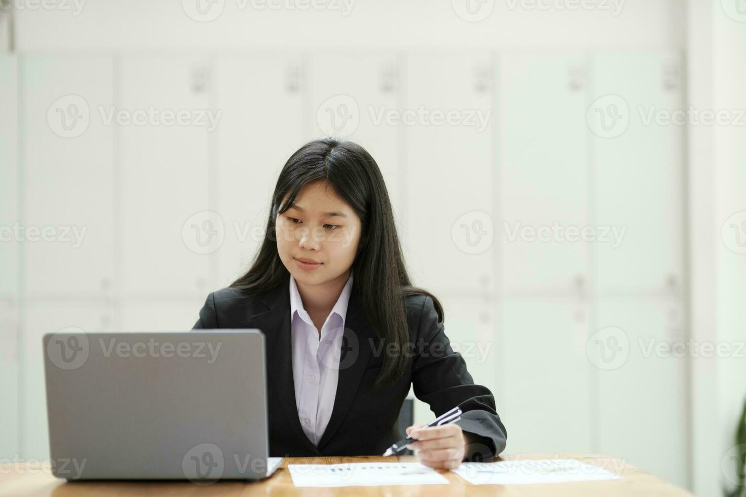 Businesswoman working at office using laptop. photo