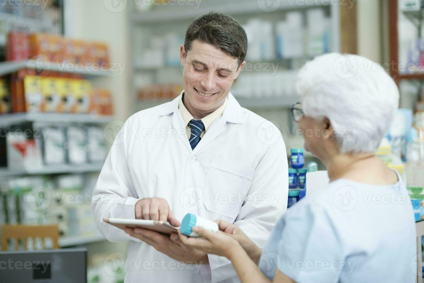 Pharmacist talking to a client about prescribed medications. photo