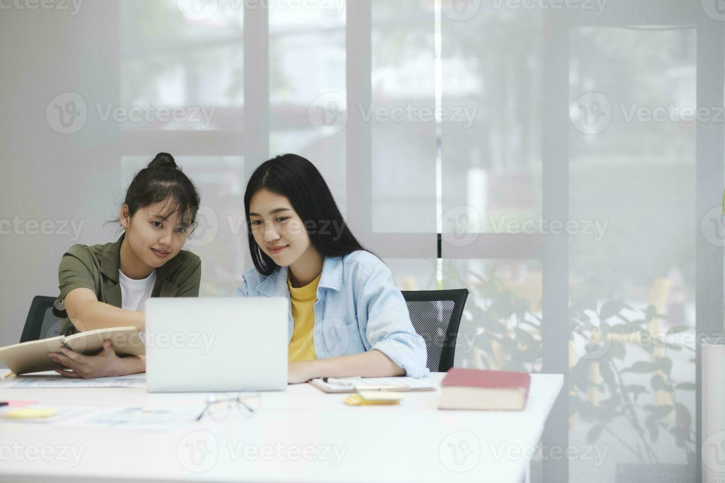 Young asian university students studying learning discuss working on computer. photo