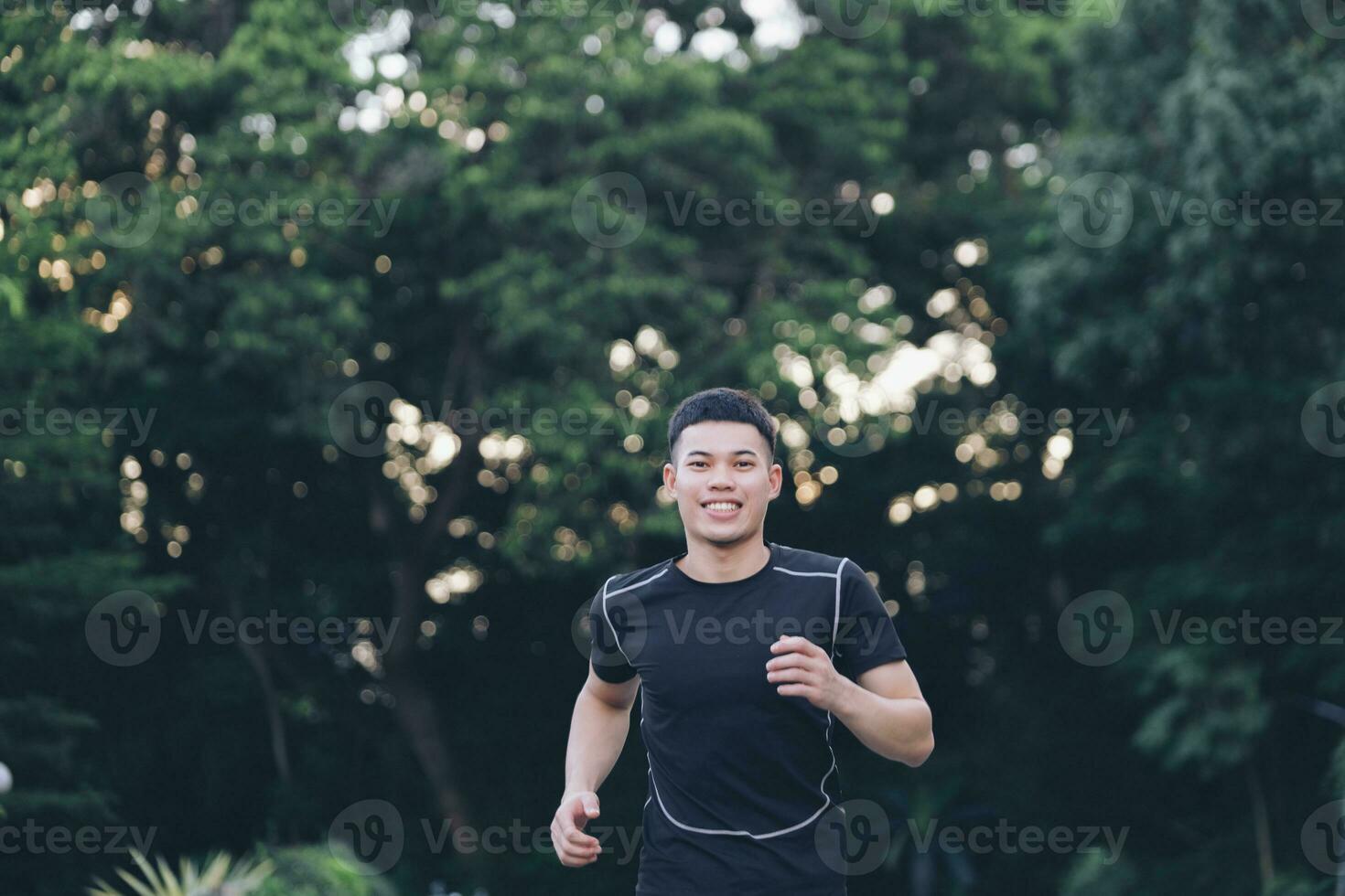 Athletic young man running in the nature. photo