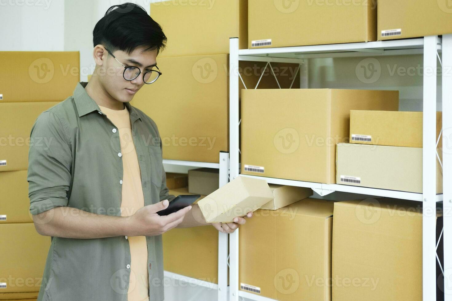Online store owner checking orders for packaged product. photo