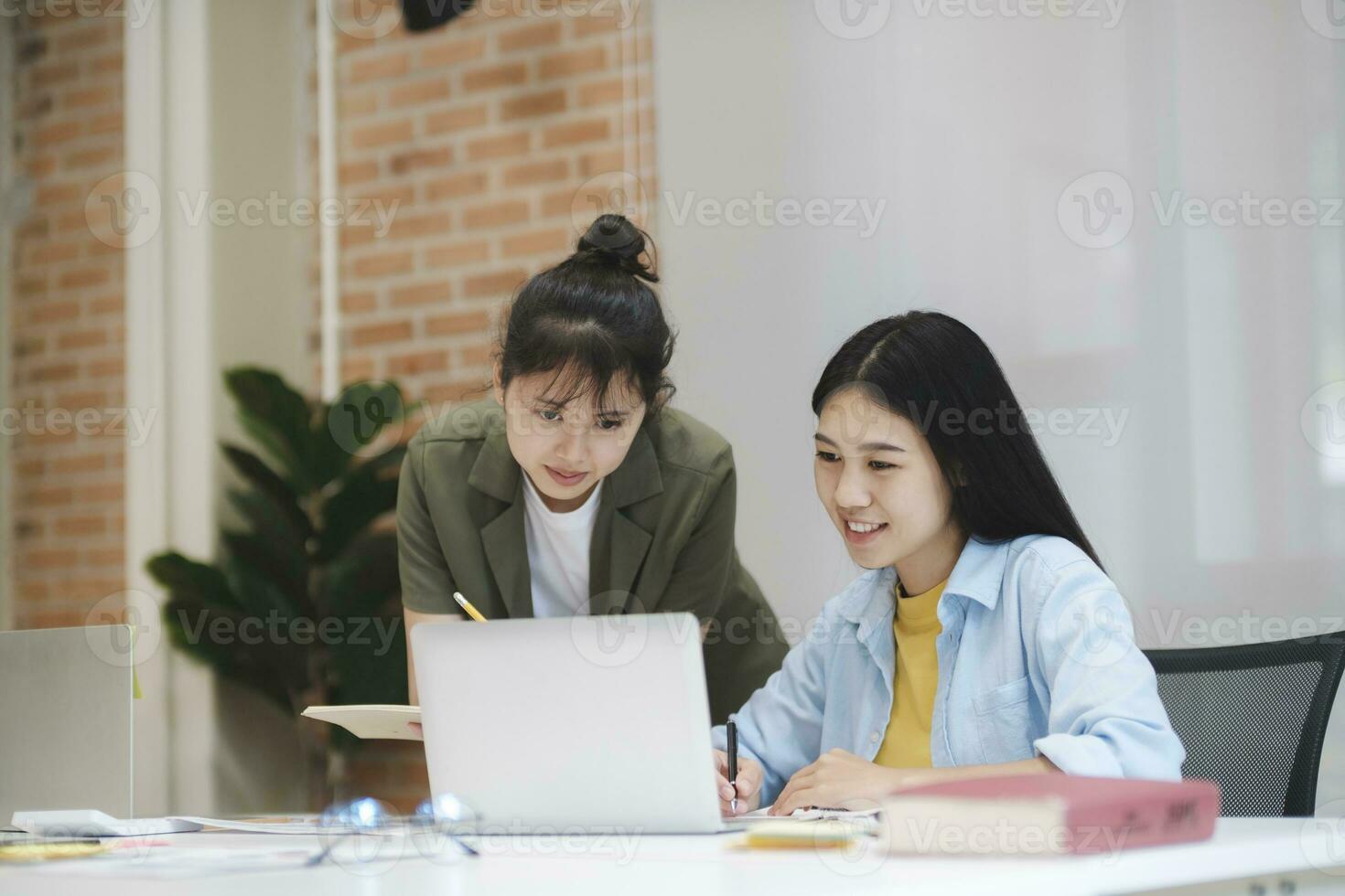 Young asian university students studying learning discuss working on computer. photo