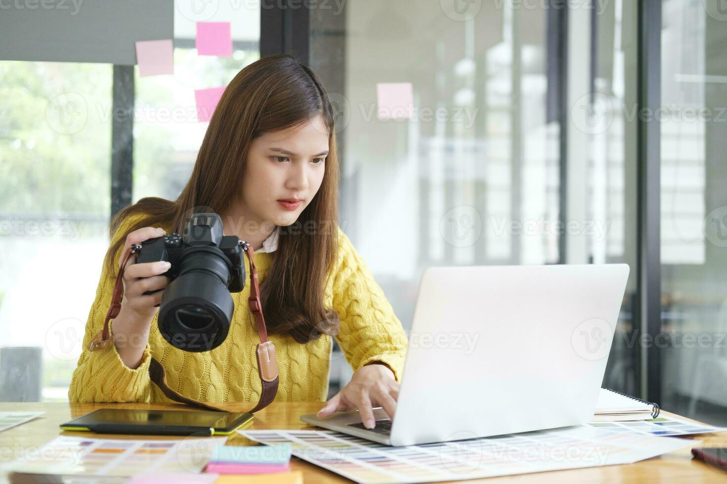 Young Asian Graphic Designer Working on Computer. photo