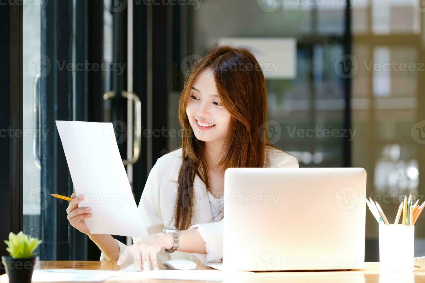 Businesswoman is working at office and using laptop. photo