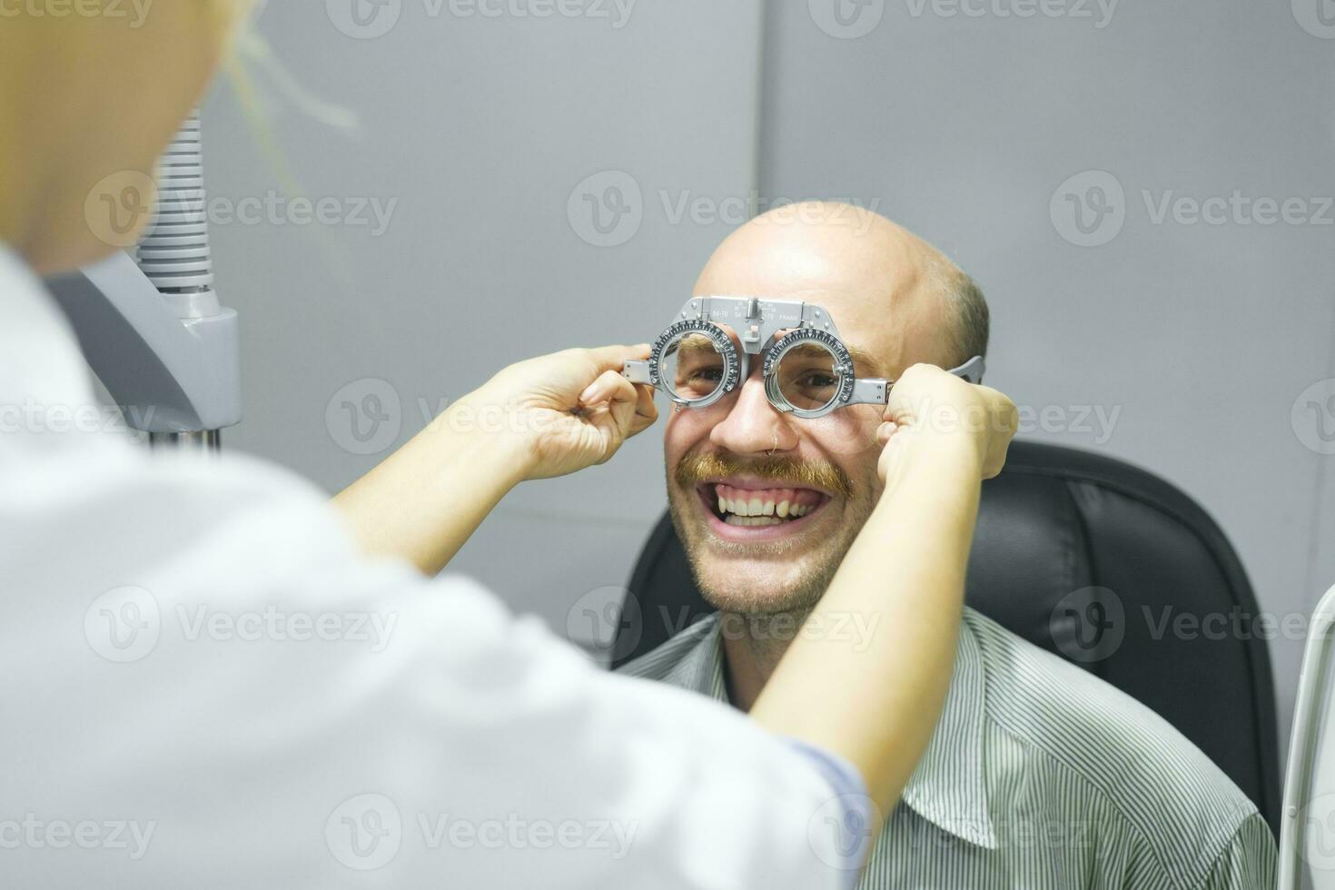 Man examining eyesight in optical clinic. photo