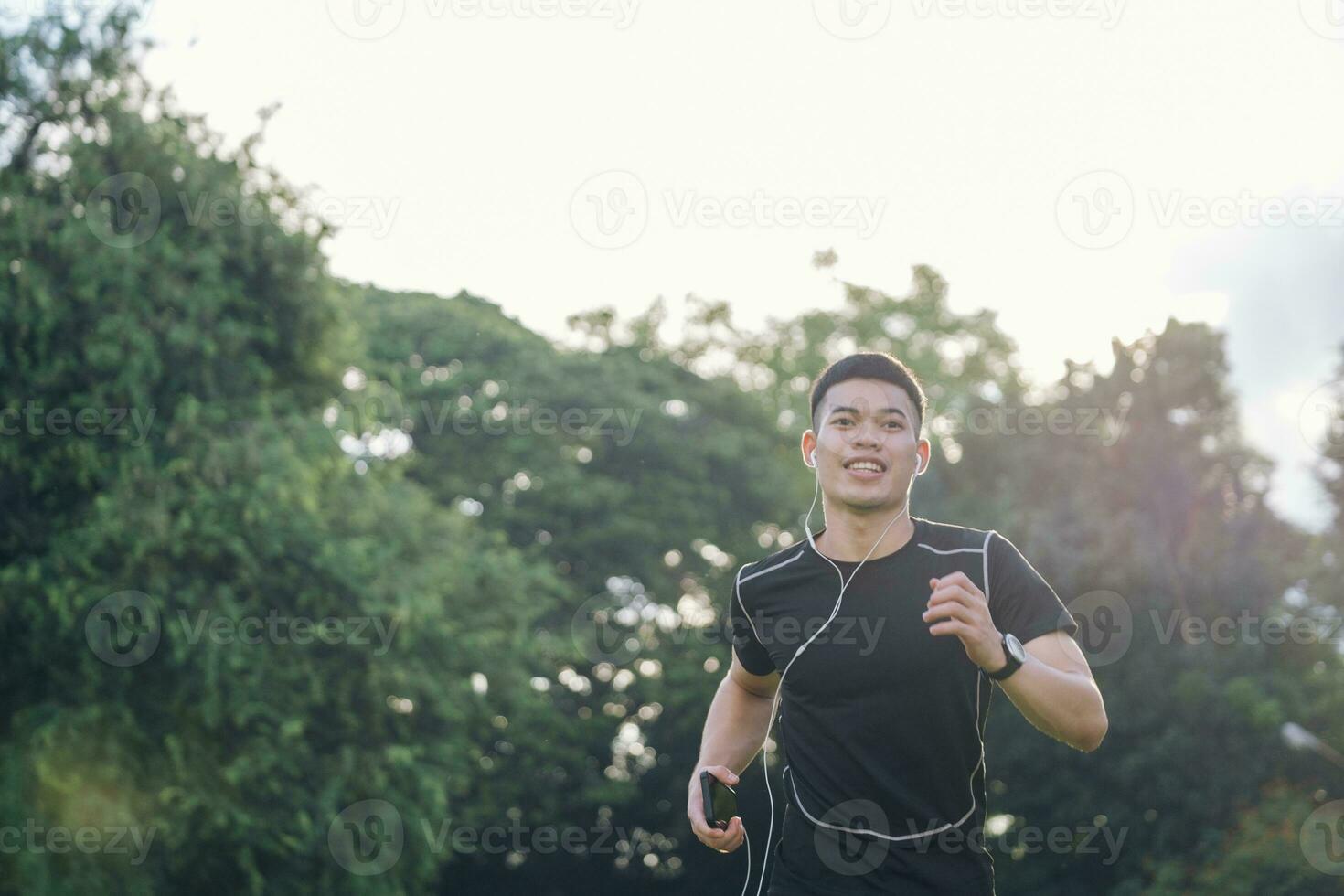Athletic young man running in the nature. photo