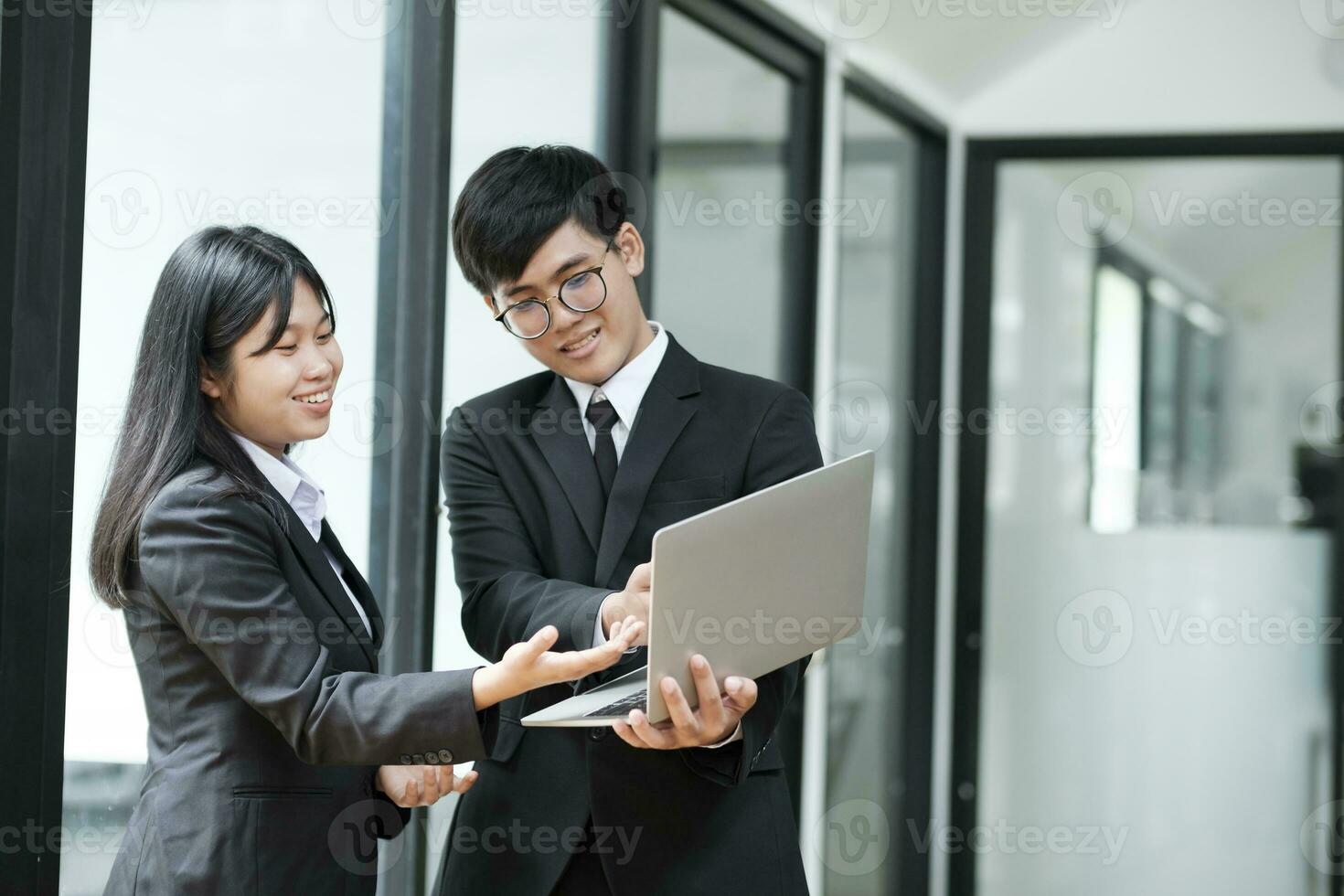 Two businesspeople talking and discussing while standing. photo