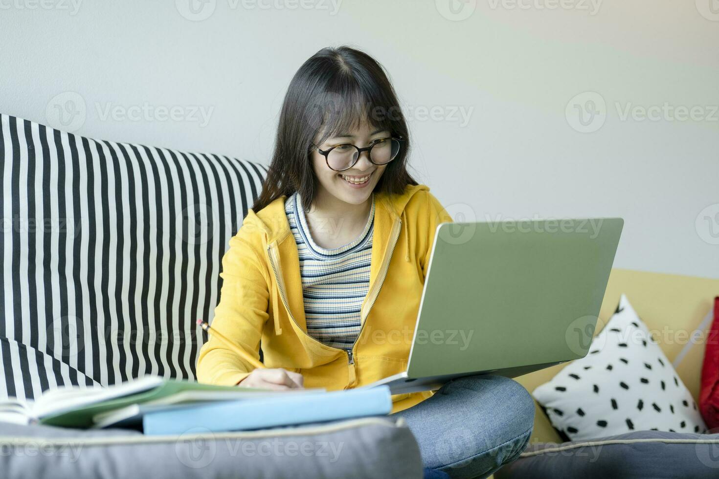 Young collage student using computer and mobile device studying online. photo