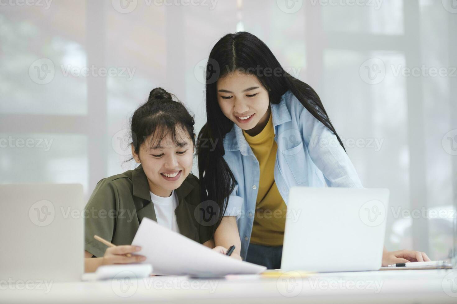 Young asian college university students studying learning discuss working on computer. photo