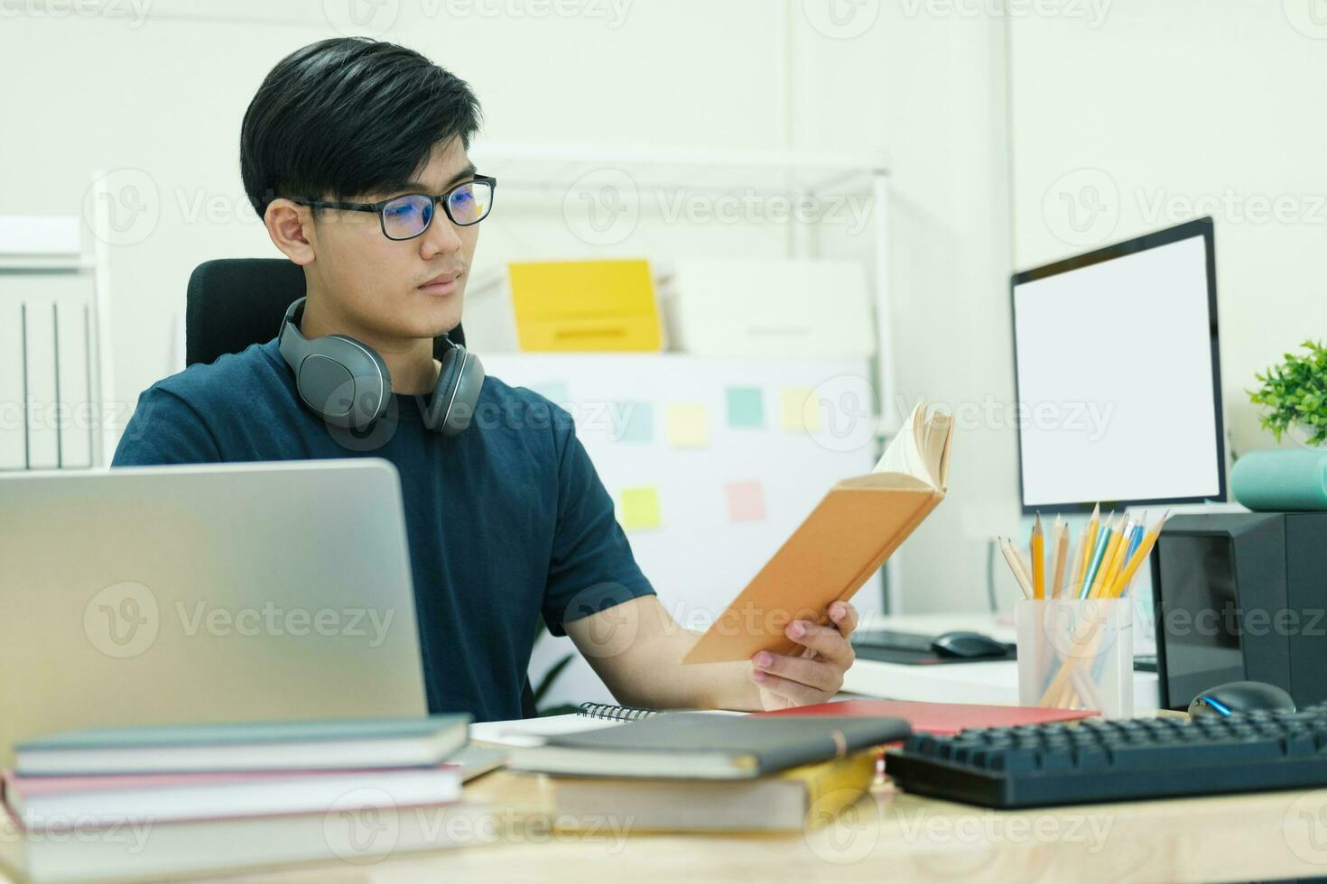 Young man study in front of the laptop computer at home photo