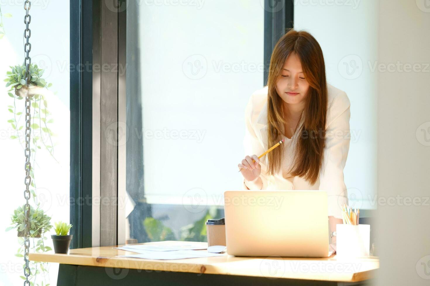 Businesswoman is working at office and using laptop. photo