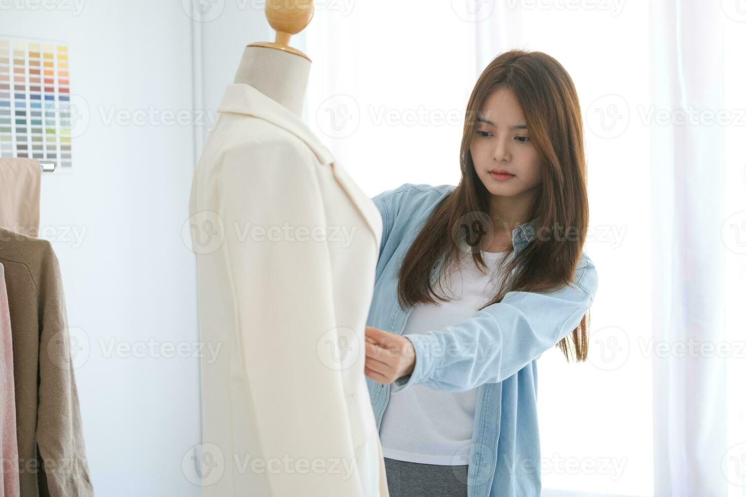 Young woman and fashion designer is create the new collections of cloth. photo