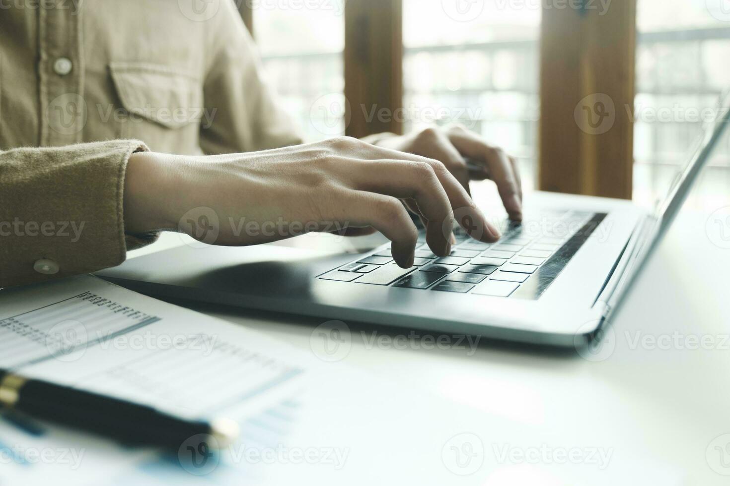 Close up of female hands while typing on laptop. photo