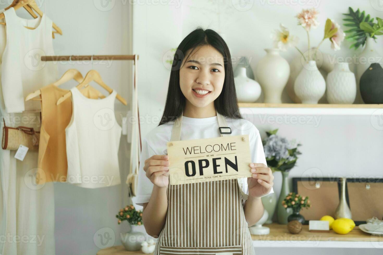 Young asian business owner turning open sign product store and ready to service for welcome the customer. photo