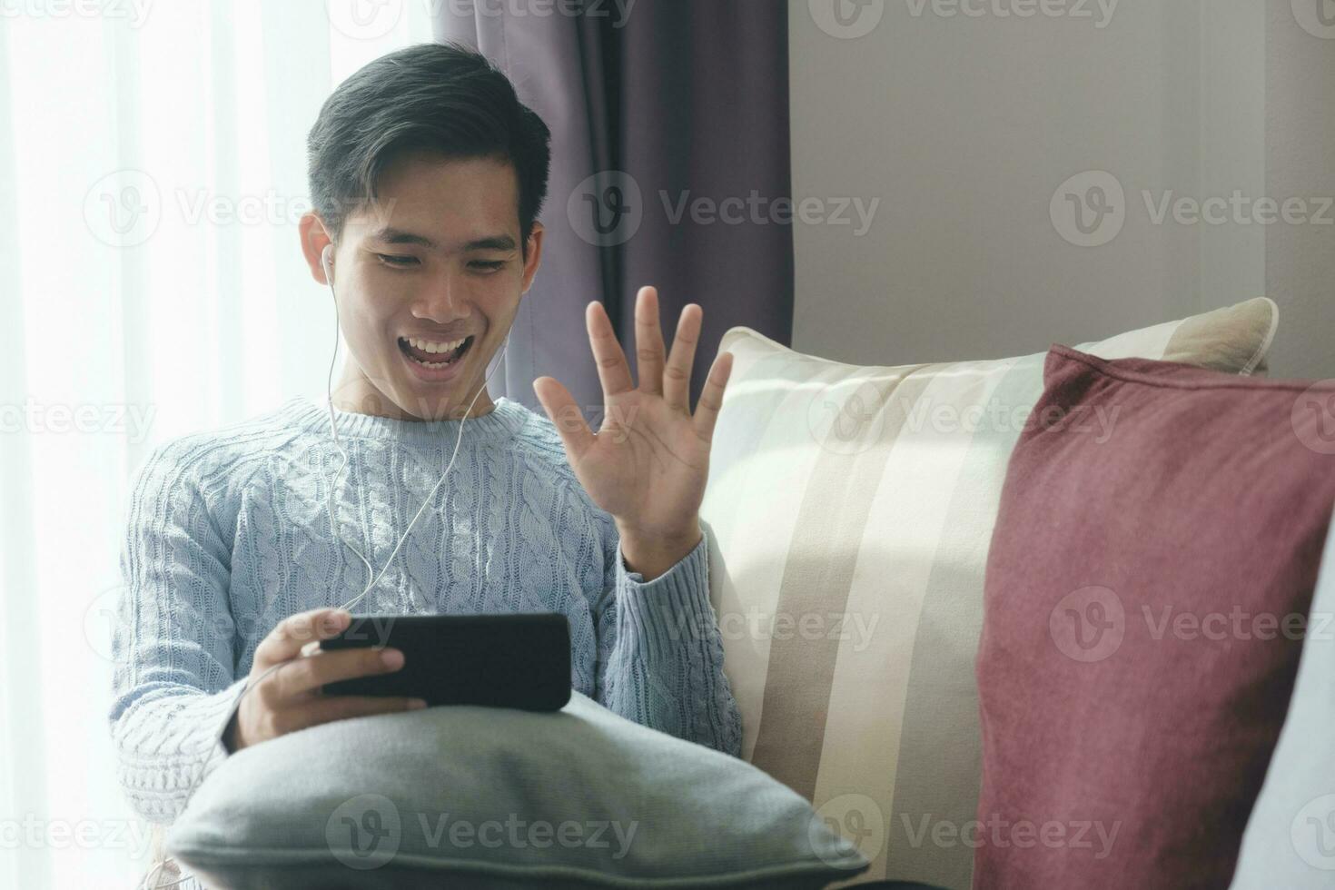 Young man using mobile device for video call. photo