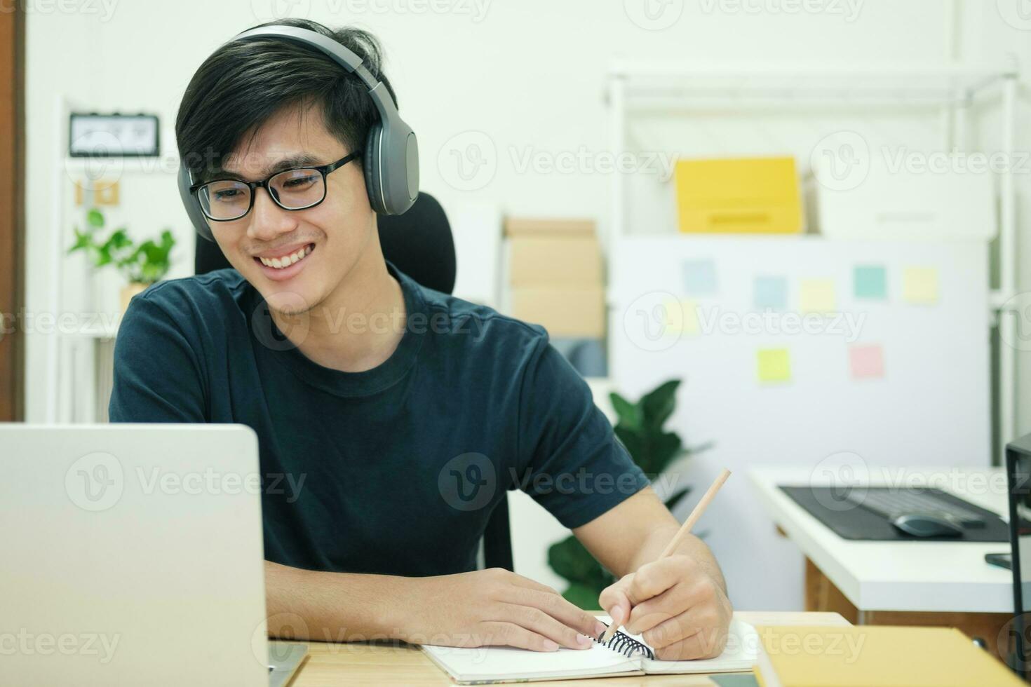 Young man study in front of the laptop computer at home photo