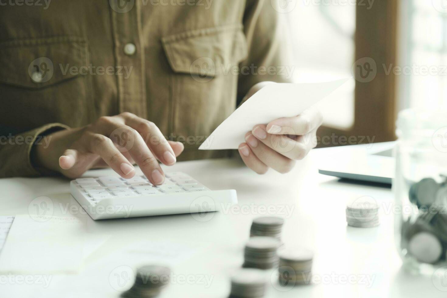 Accountant using calculator for calculate finance report in office photo