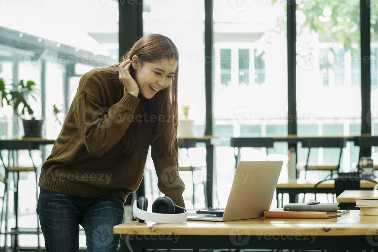 Young collage student using computer and mobile device studying online. photo