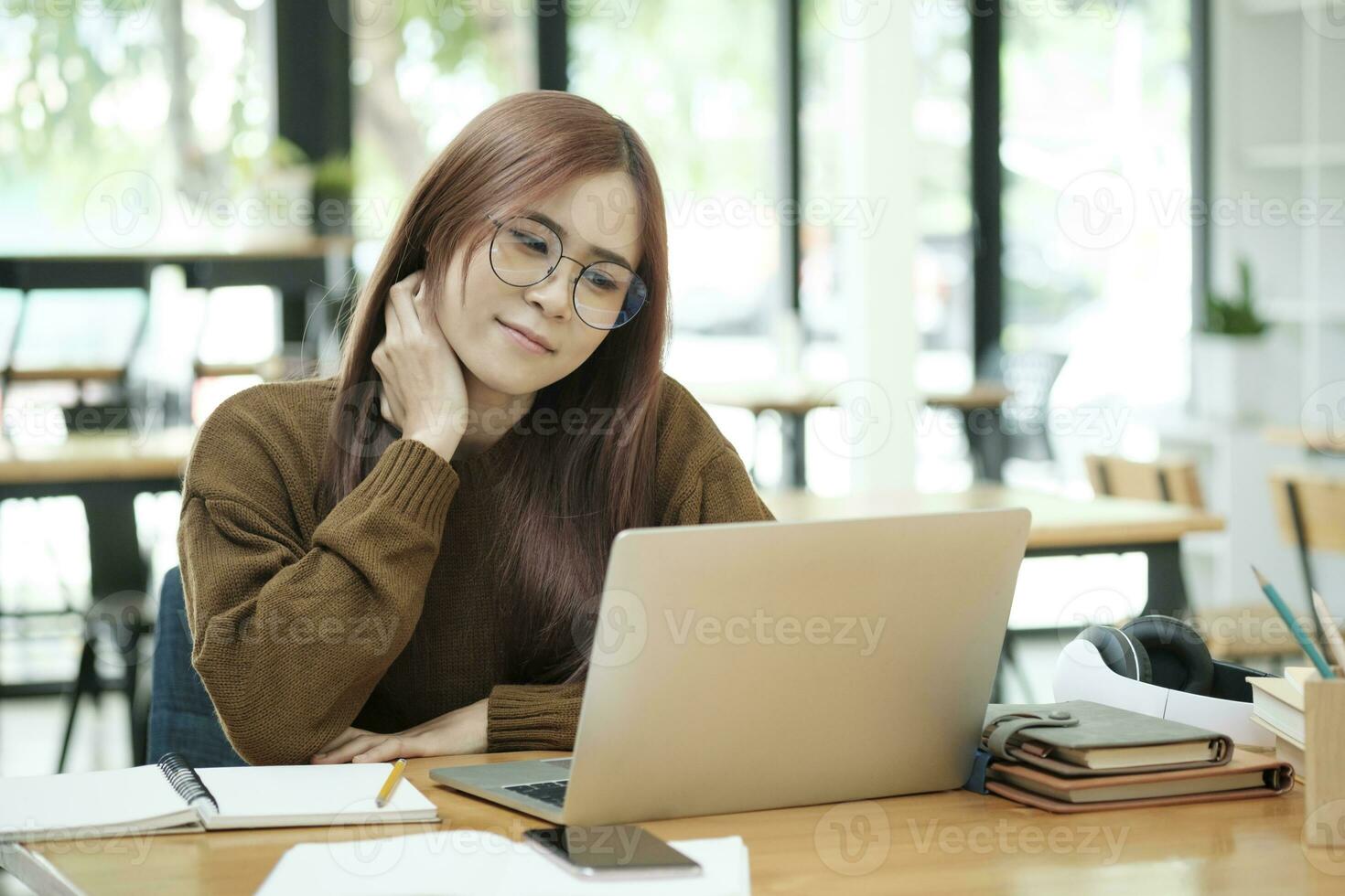 Young woman studying or working online using laptop. photo