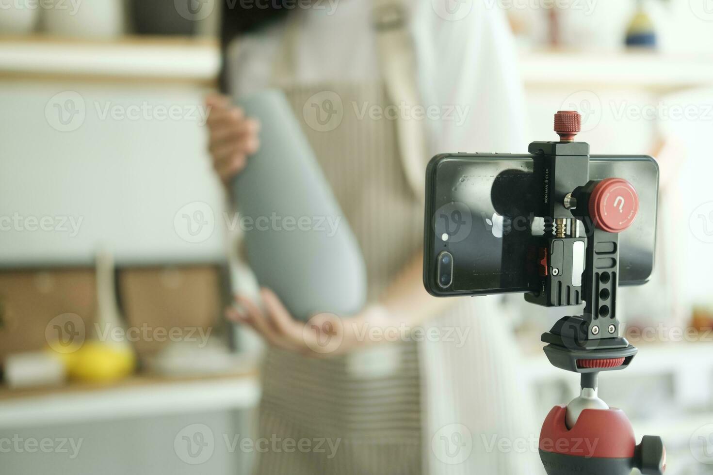 Close up young asian businesswoman fashion blogger showing ceramic products with smiling face. photo