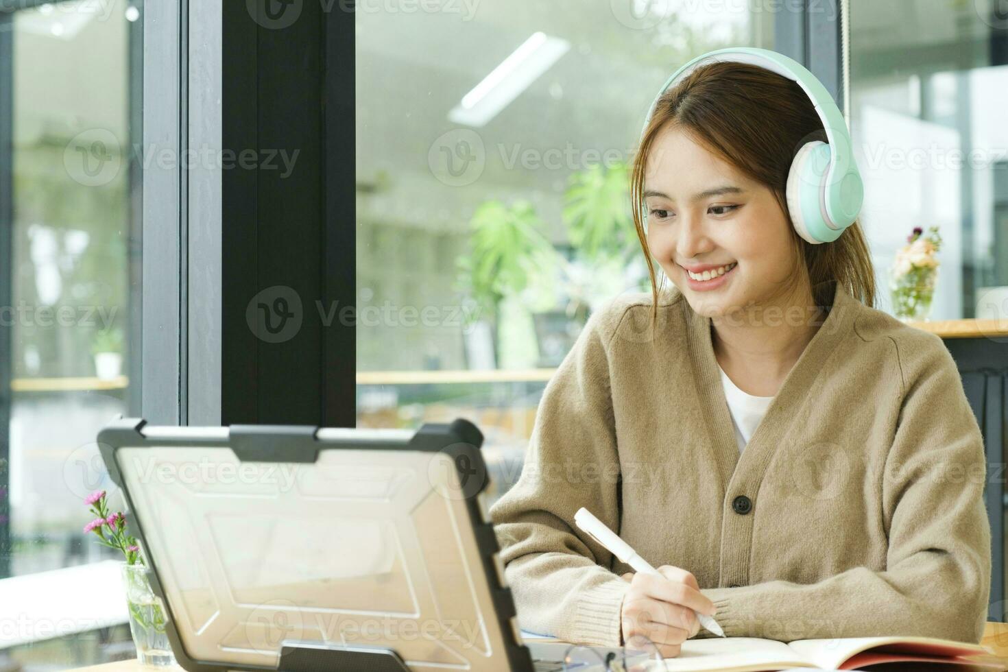 Young female college student uses a computer to access the Internet for online learning. photo