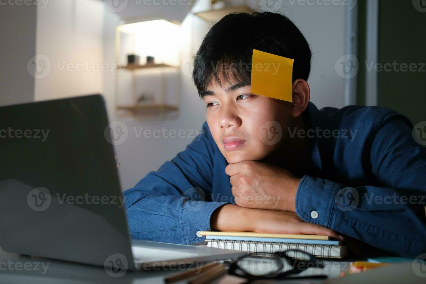 Exhausted tired workaholic young man with sticky note photo