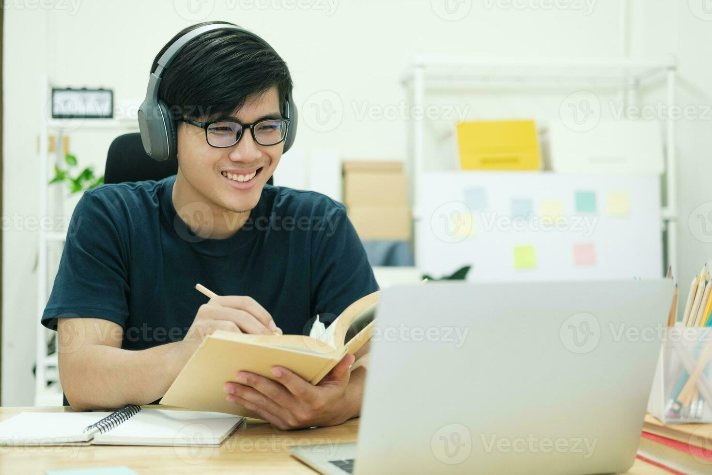 Young man study in front of the laptop computer at home photo
