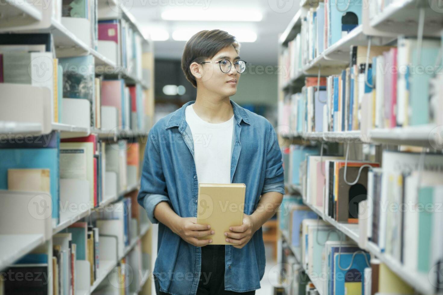 Student reading book at library. photo