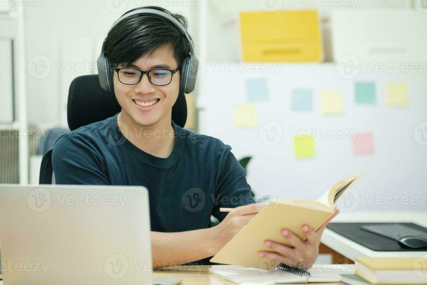 Young man study in front of the laptop computer at home photo