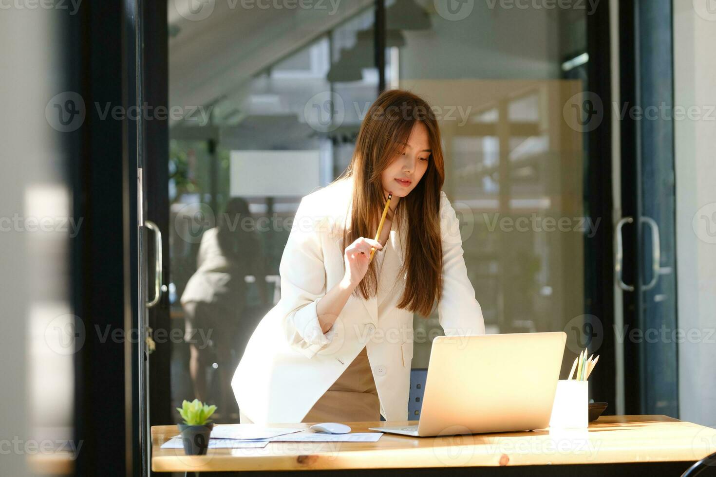 Businesswoman is working at office and using laptop. photo