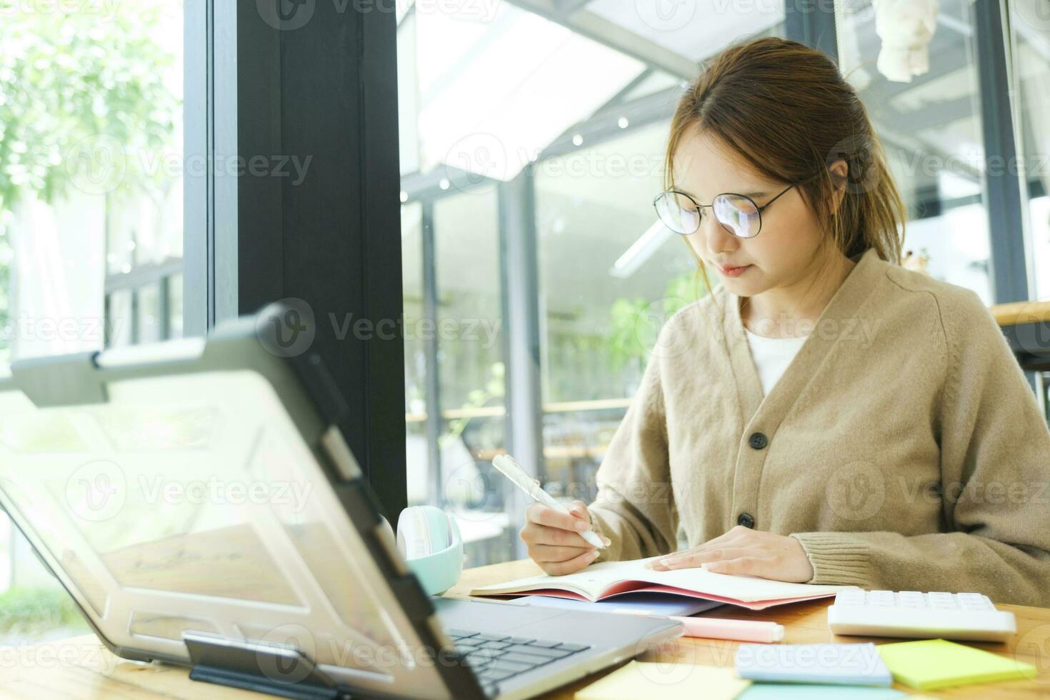 Young female college student uses a computer to access the Internet for online learning. photo
