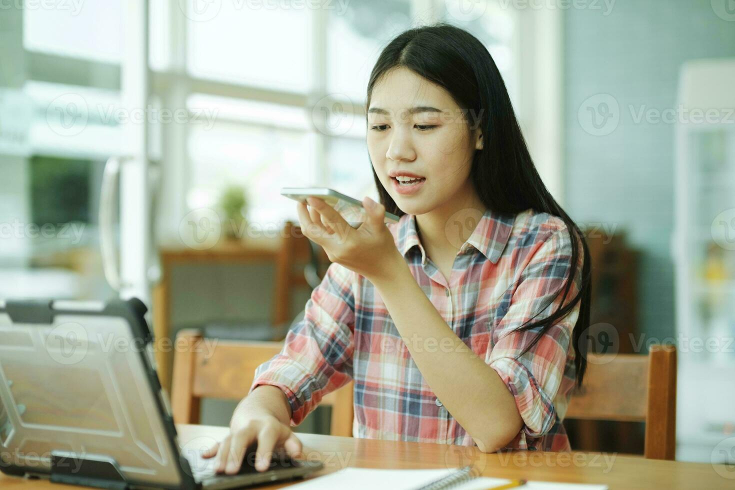 Young businesswoman talking with customer on mobile phone. photo