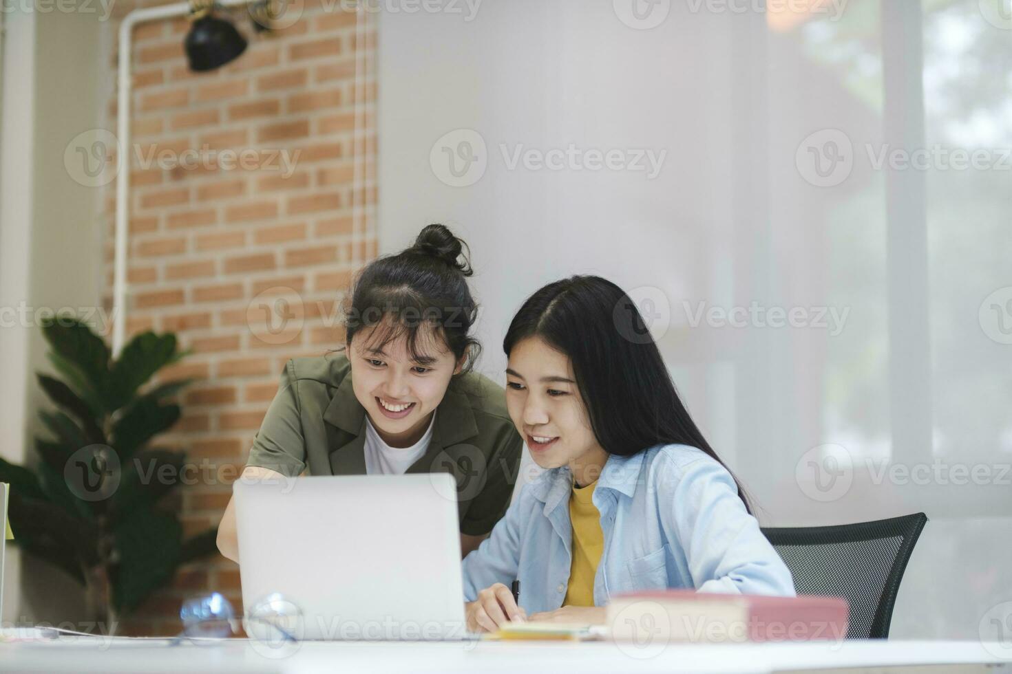Young asian university students studying learning discuss working on computer. photo