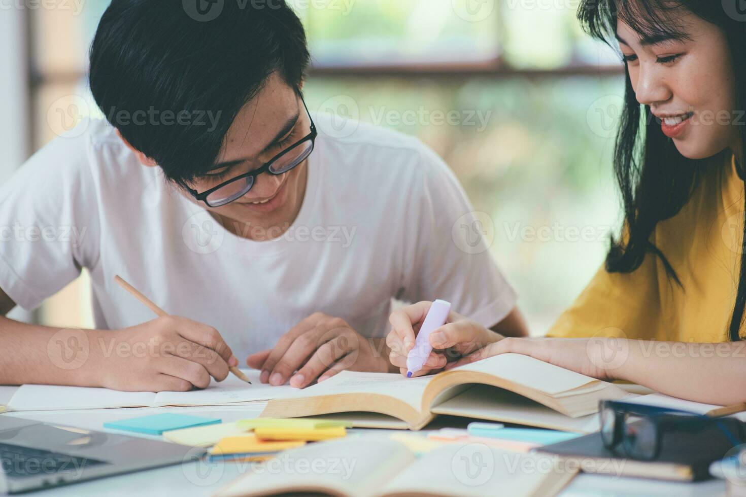 Young students campus helps friend catching up and learning. photo