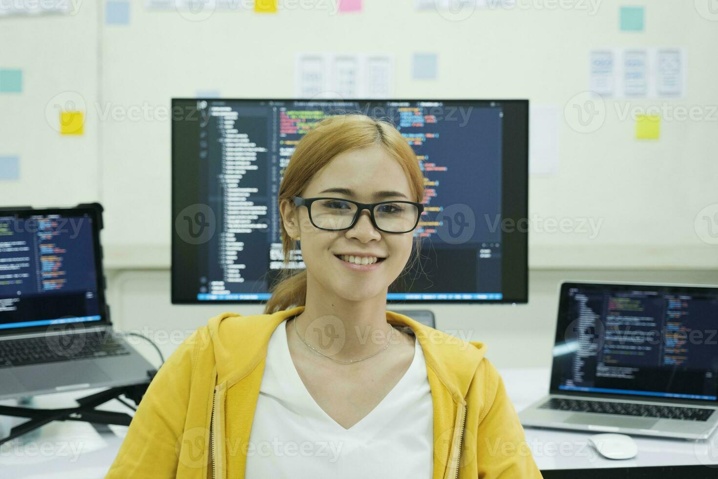 Young programmer or IT specialist satisfied with her work done. photo