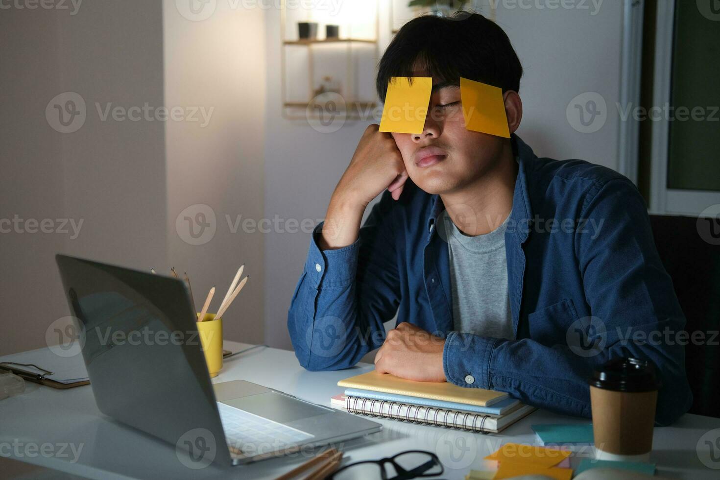 Exhausted tired workaholic young man with sticky note photo