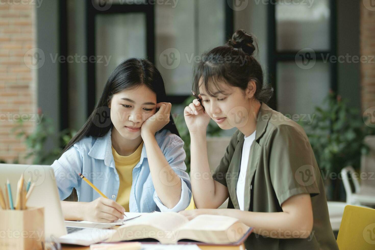 Young asian students campus helps friend catching up and learning. photo