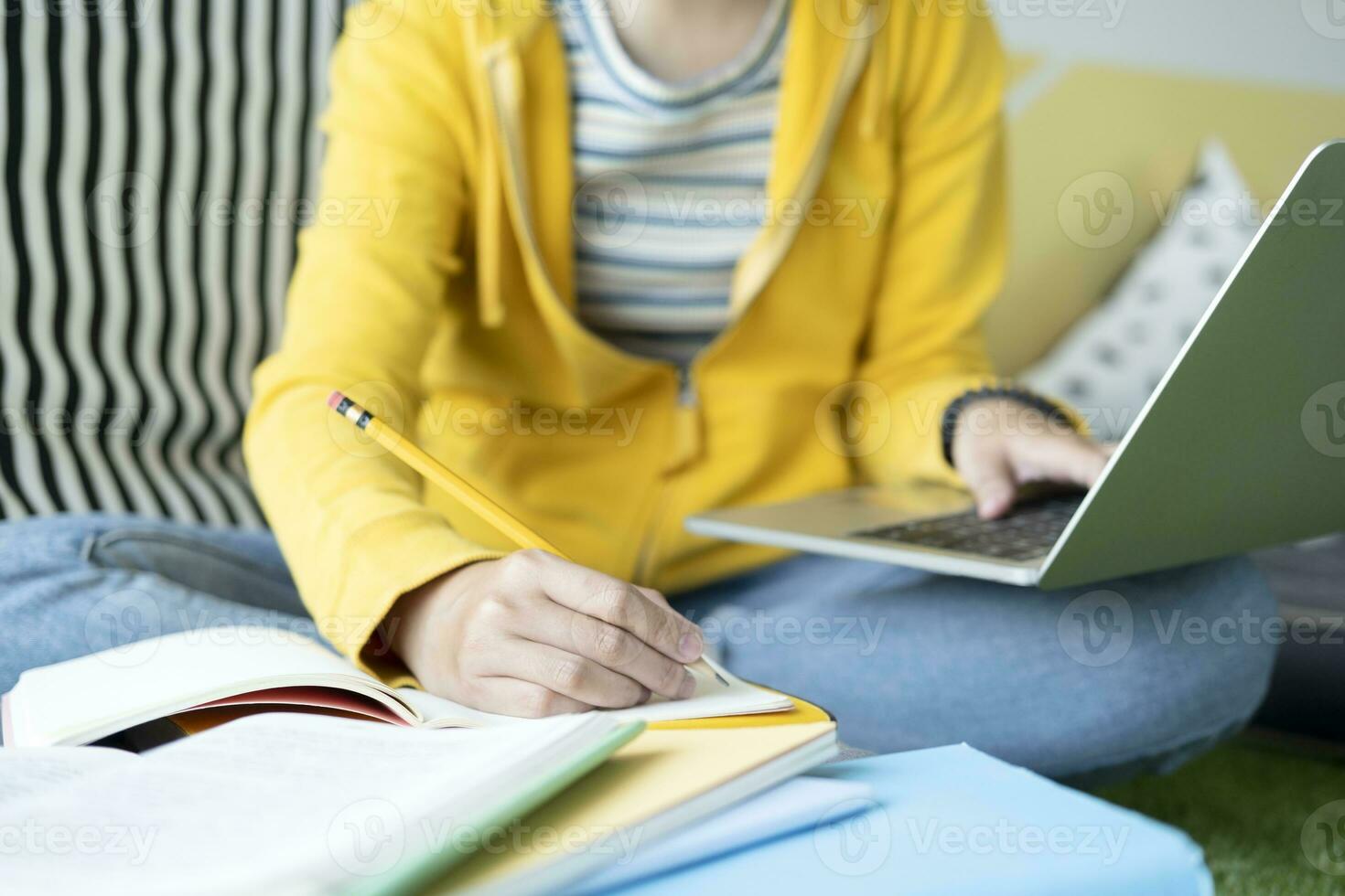 Young collage student using computer and mobile device studying online. photo