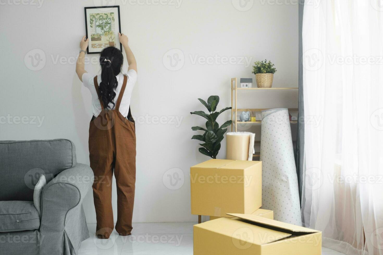 Woman decorating new home while moving in to new house or apartment. photo