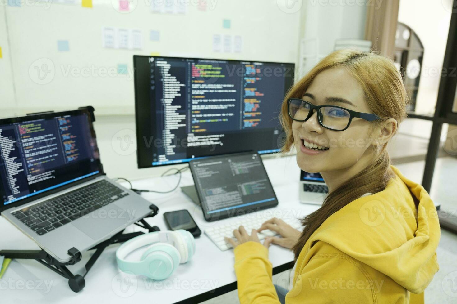 Young programmer or IT specialist satisfied with her work done. photo